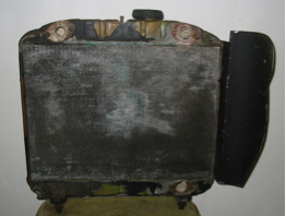 A very old radiator is sitting on a chair
