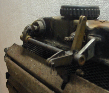 A close up of a metal object with a wheel on top