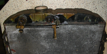 A very old radiator is sitting on a table.
