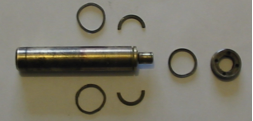 A metal cylinder with rings around it on a white surface