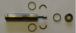 A metal cylinder with rings around it on a white surface
