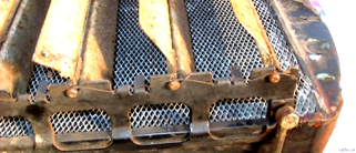 A close up of a metal object with a mesh covering