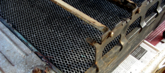 A close up of a metal grille on a newspaper