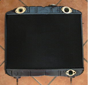 A black radiator is sitting on a tiled floor