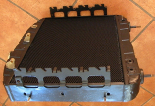 A black radiator is sitting on a tiled floor