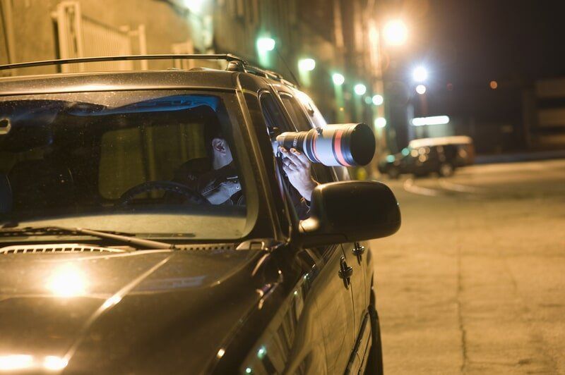 A Man Is Taking A Picture Out Of The Window Of A Car — Surveillance NQ In Townsville, QLD