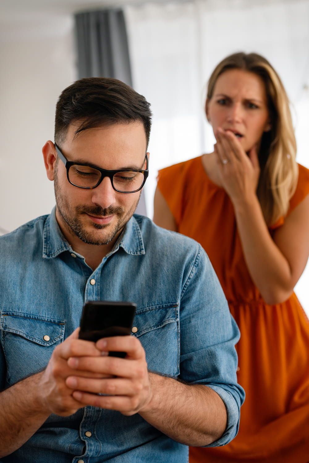A Man Is Looking At His Cell Phone While A Woman Looks On — Surveillance NQ In Aitkenvale, QLD