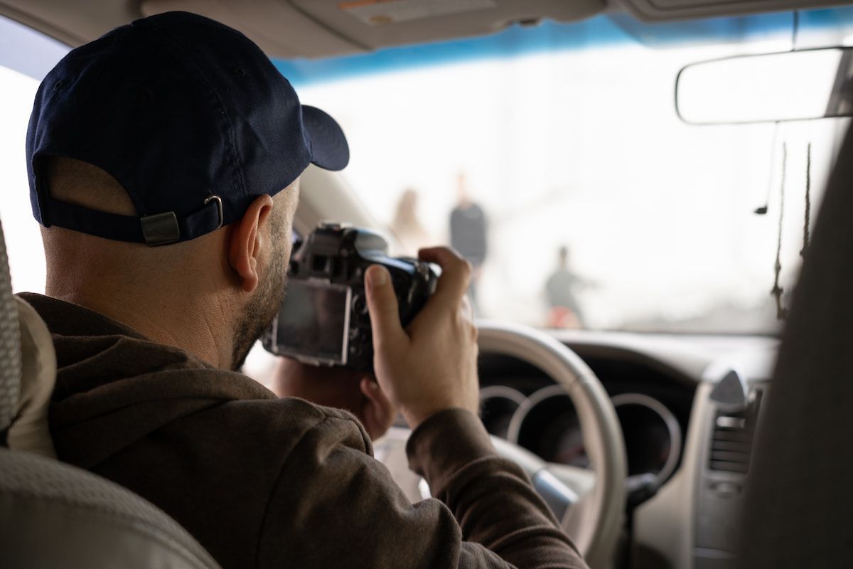 A Person Is Holding A Camera Out Of The Window Of A Car — Surveillance NQ In Aitkenvale, QLD