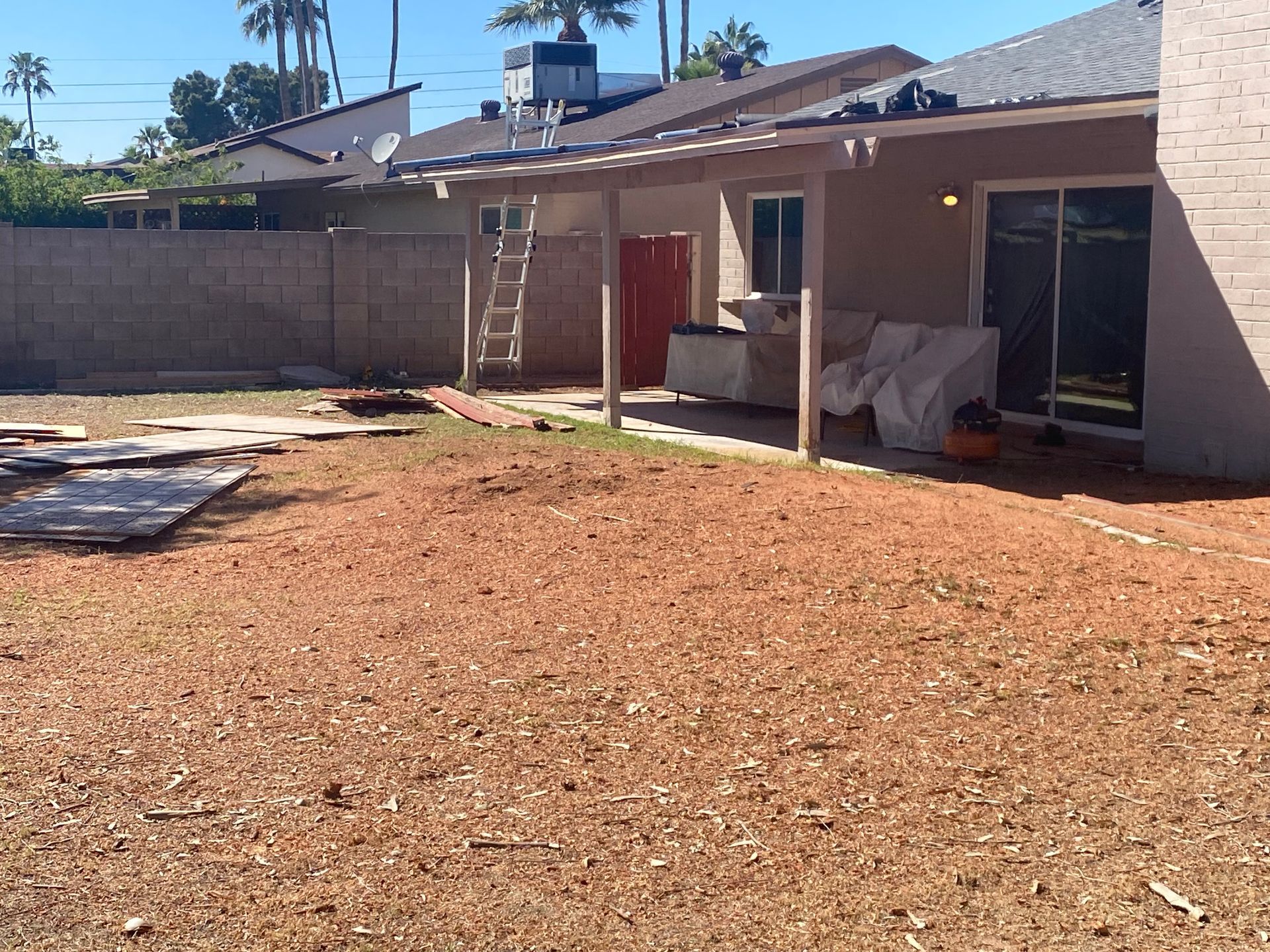 The backyard of a house with a covered patio