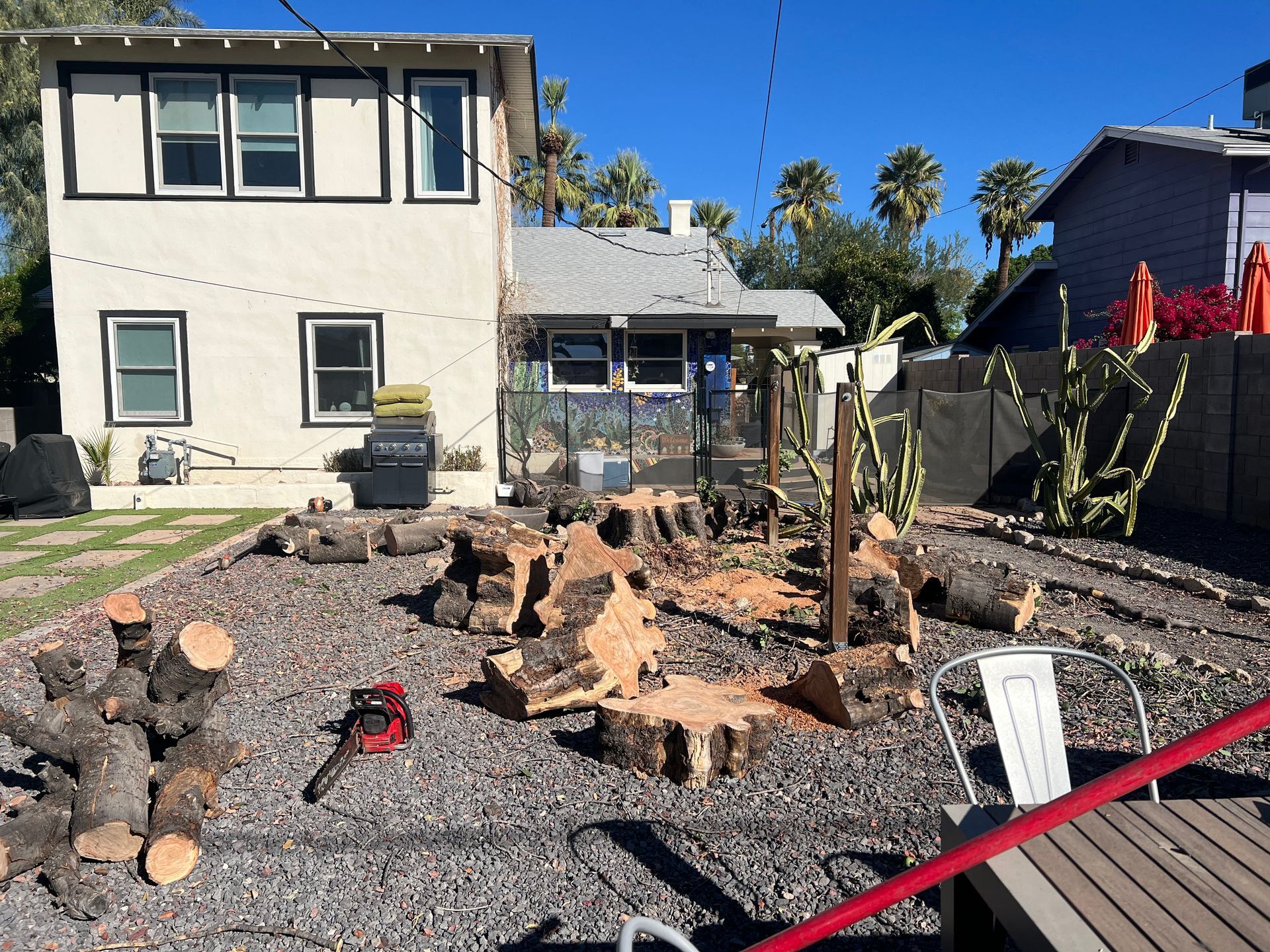 A house with a lot of logs in front of it