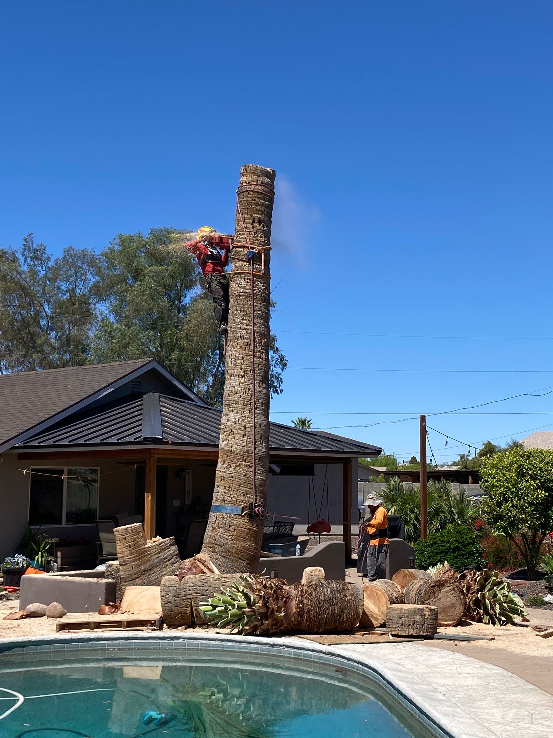 A man is climbing up a chimney next to a pool