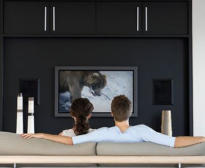 Couple watching television in living room - Electronic Repair in South Hackensack, NJ
