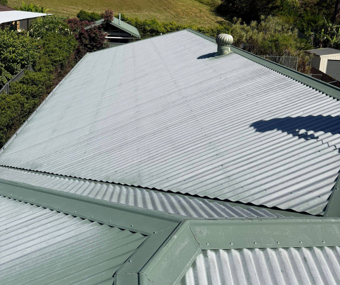 Corrugated metal roof with green trim, viewed from above.