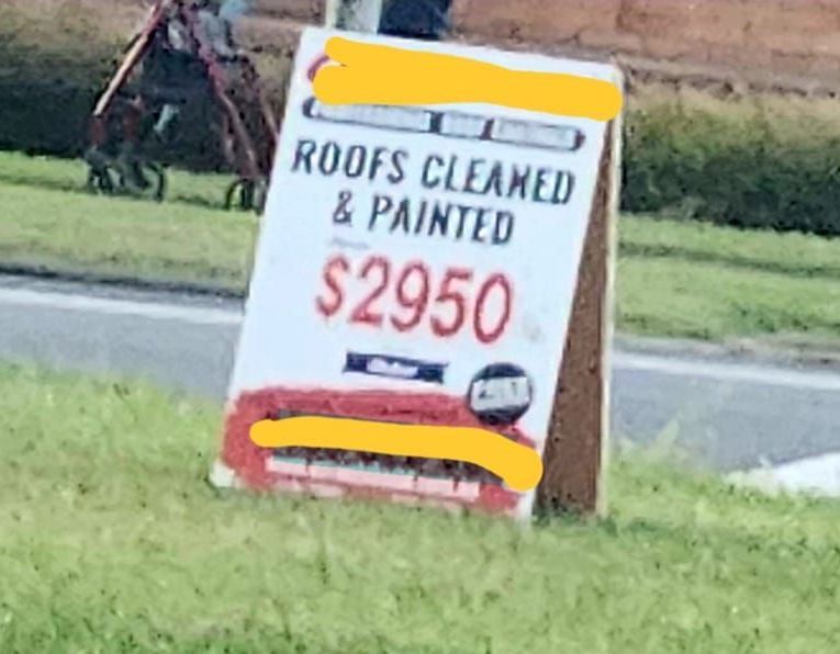 Cheap roof restoration advertisement on a sandwich board