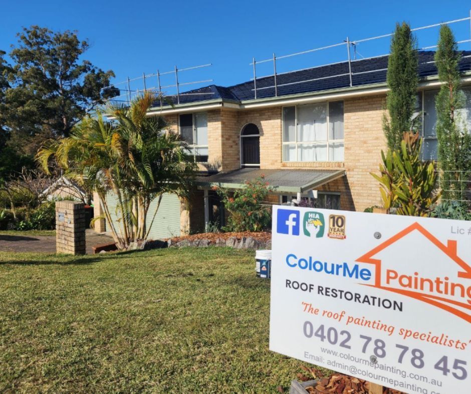 A house with a sign in front for hiring a professional painting contractor.