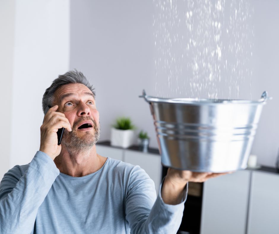 water leak dripping from the ceiling into a bucket