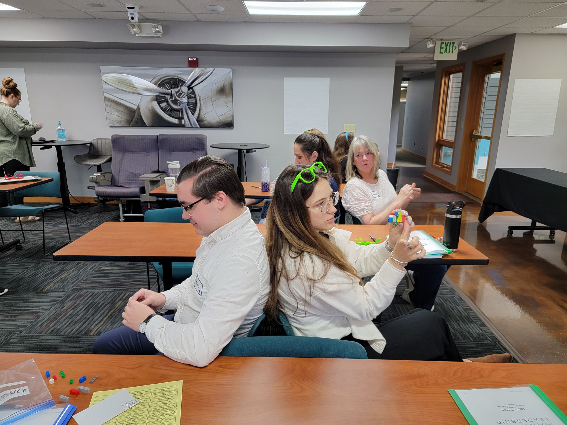 A group of people are sitting at tables in a room.