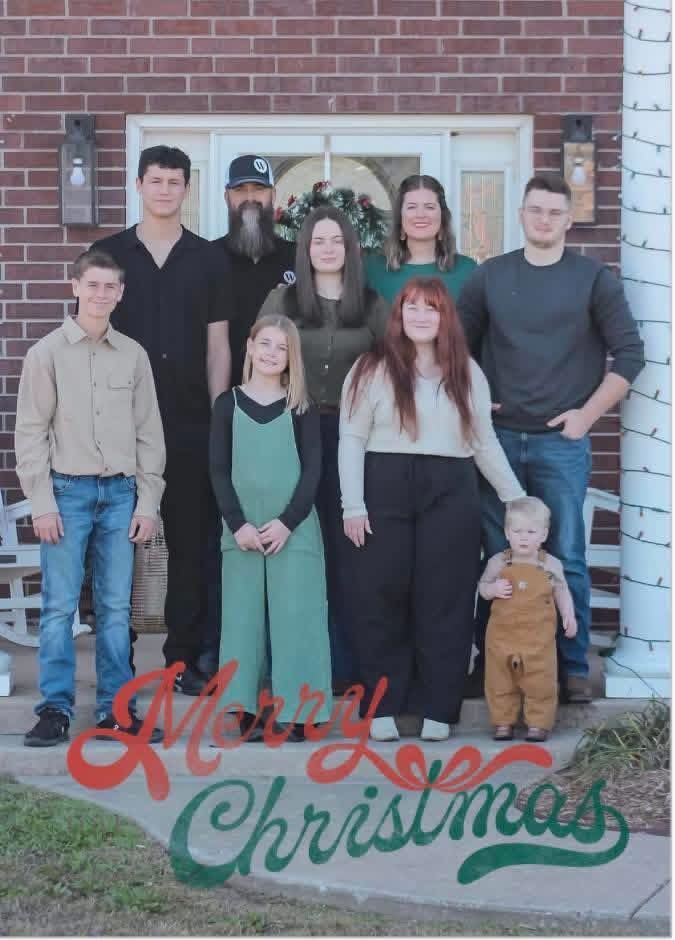 Family portrait posing on porch with Merry Christmas text.