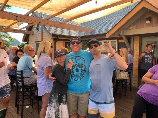 Friends enjoying drinks at an outdoor bar on Nantucket Island highlighting summer nightlife and coastal lifestyle
