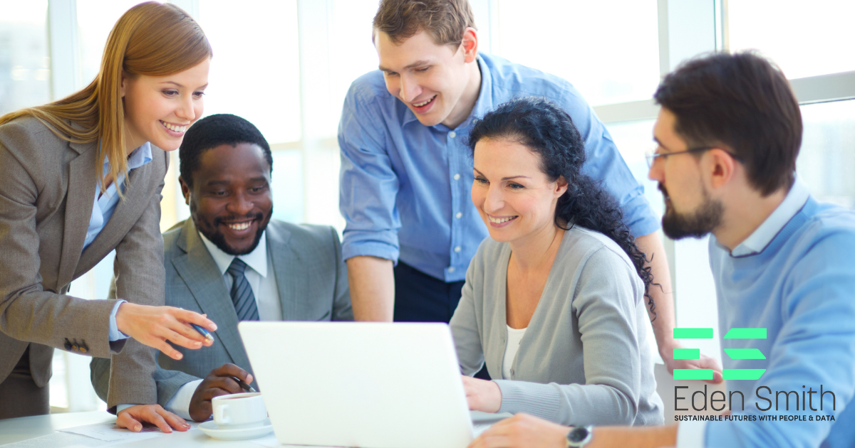 5 People sitting around a laptop