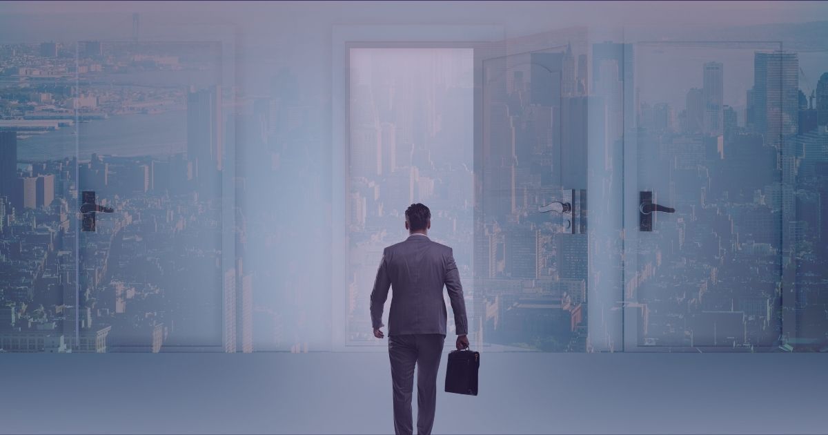 Image of a man with a suitcase standing at doors