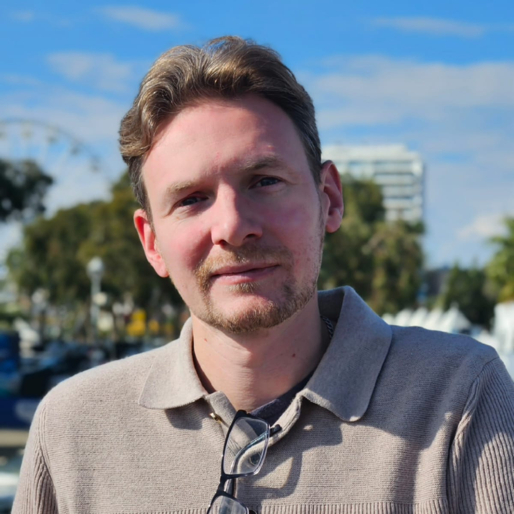 headshot of white male in front of london eye