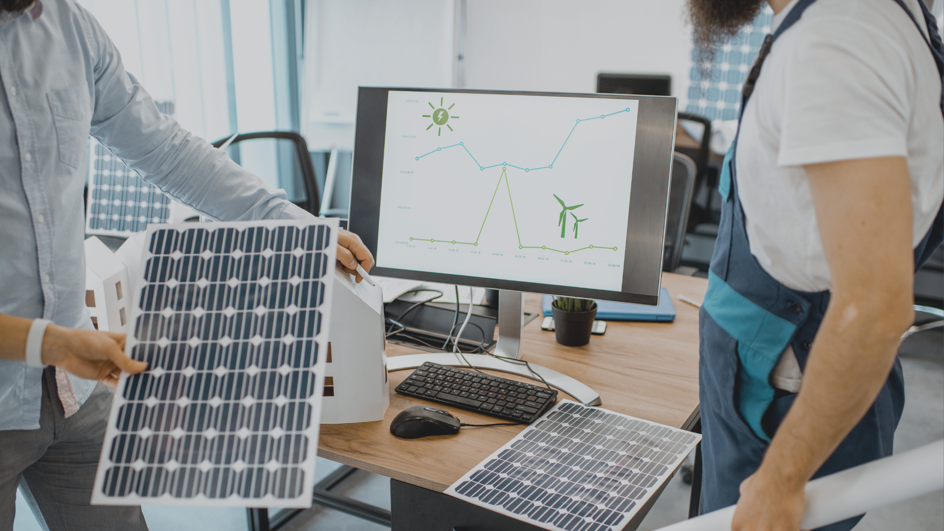 people holding a solar panel near a computer