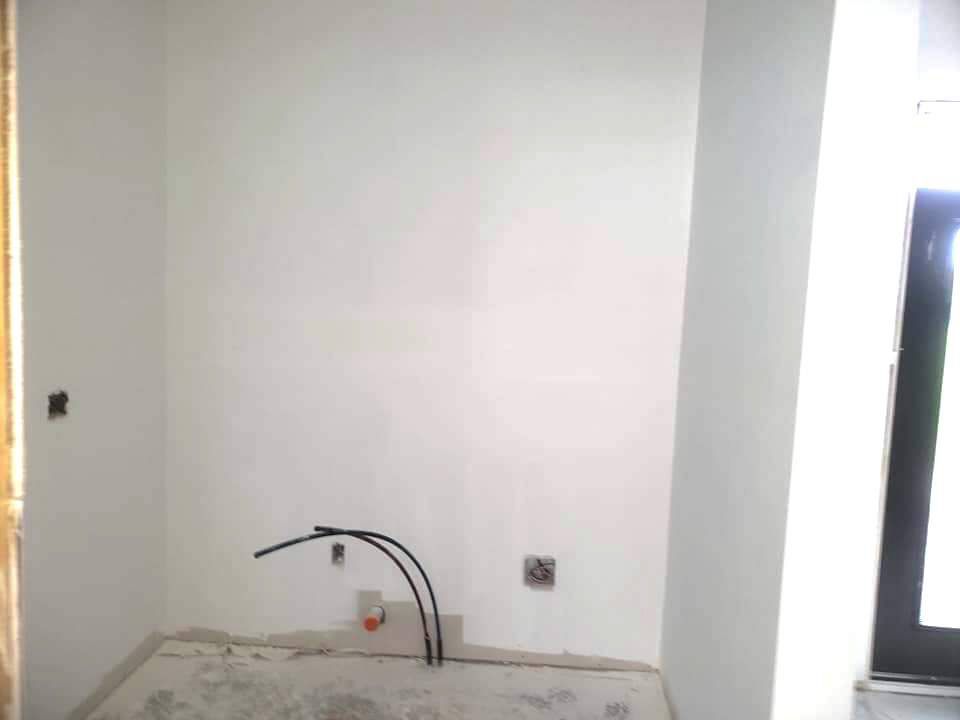 progress picture of completed paint ready drywall in a local business