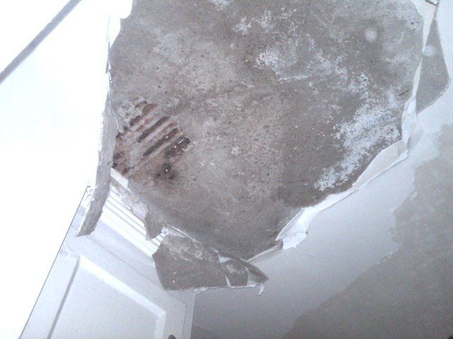 A picture of a large chunk of ceiling in need of being cut out and patched in with some new drywall.