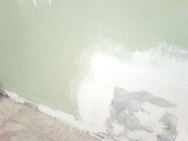 Picture of a patched drywall piece on a wall during construction