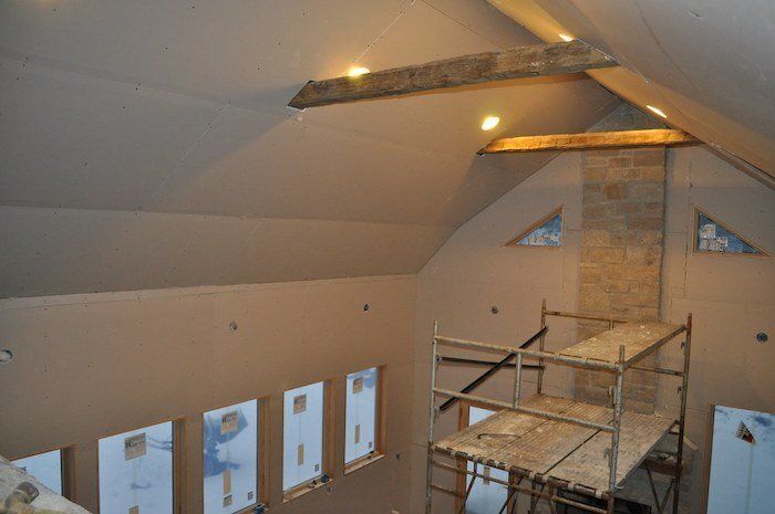 Photo of a freshly drywalled vaulted ceiling which is currently under construction in a home