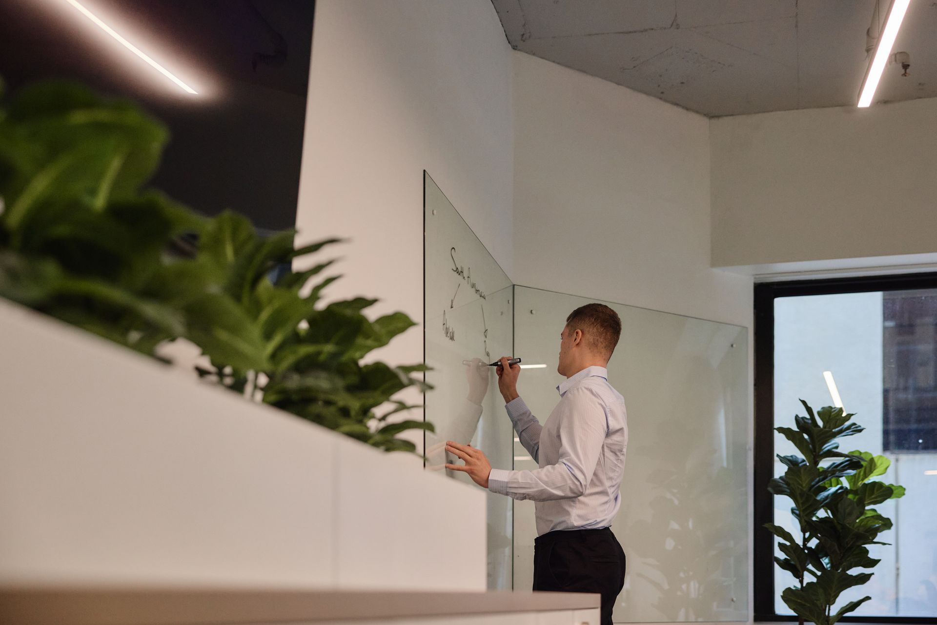 Two women are shaking hands in a living room.