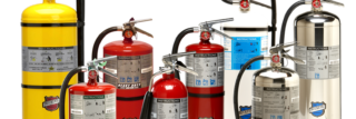 A group of fire extinguishers are lined up in a row on a white background.