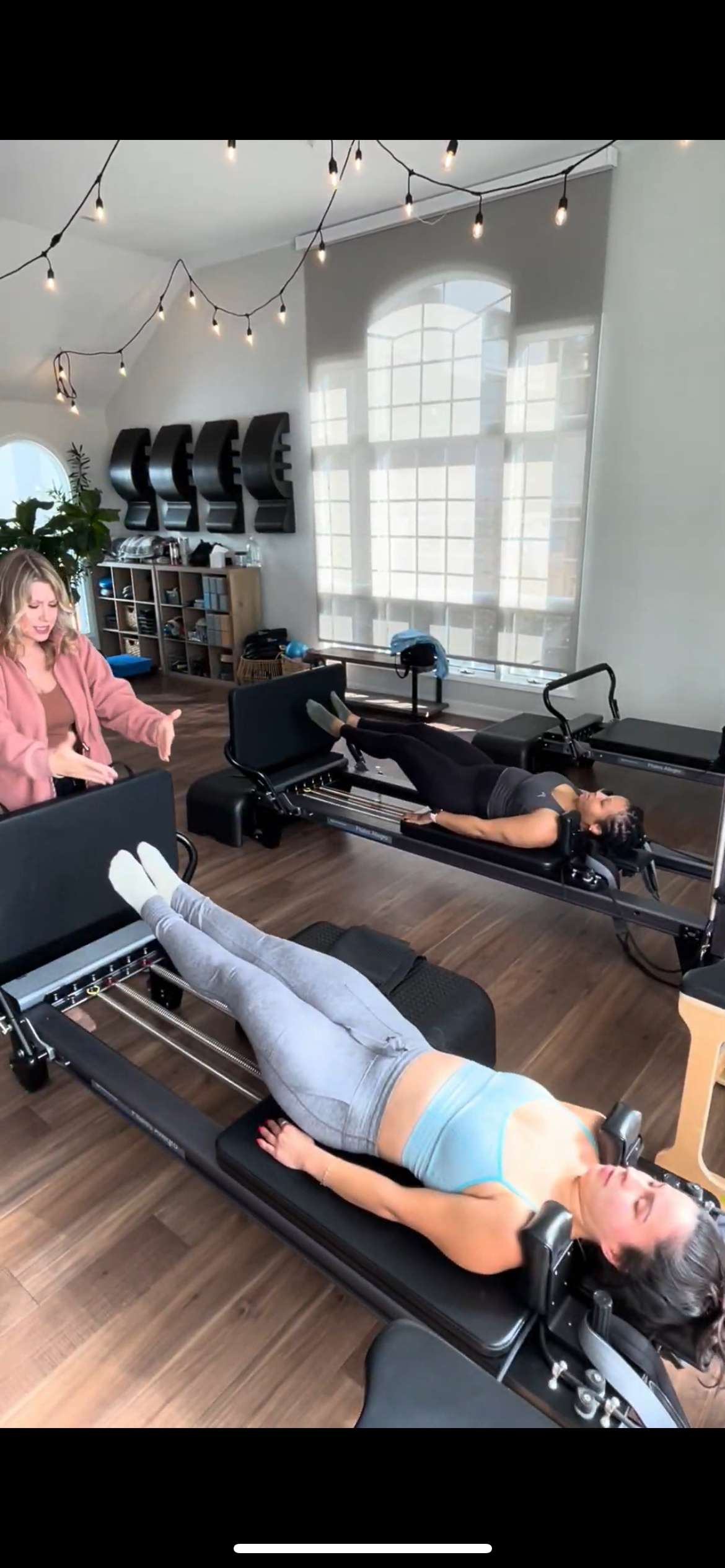 A woman is doing exercises on a pilates machine