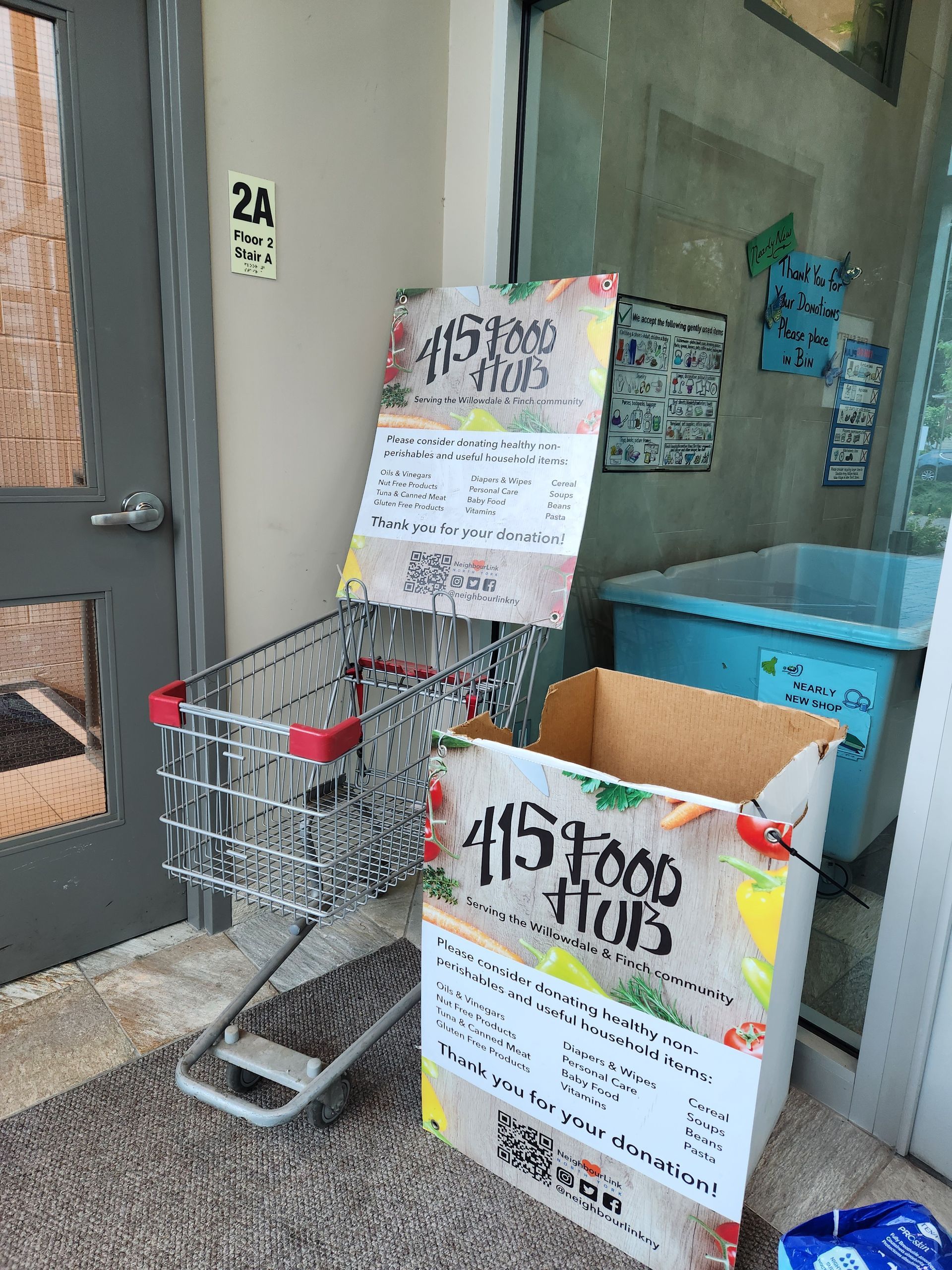 Picture of the food hub drop-off cart and box inside our main entrance.
