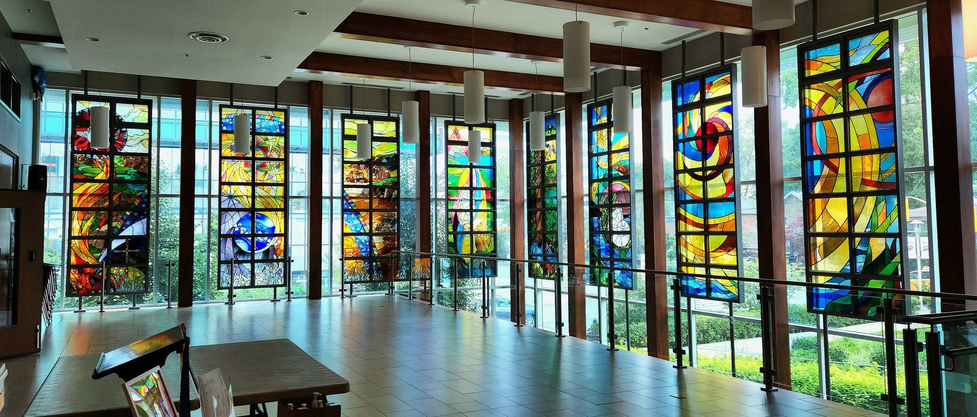 In front of Lansing's floor-to-ceiling windows are the eight stained glass windows, letting the light shine into the foyer in various colours.