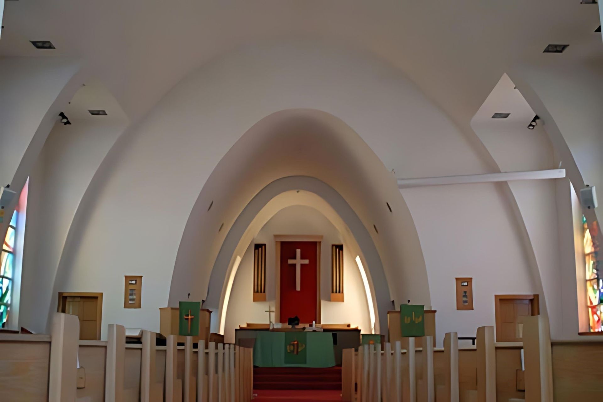 Lansing's chapel, where the new stained glass windows are just visible from between the arched ceiling beams.