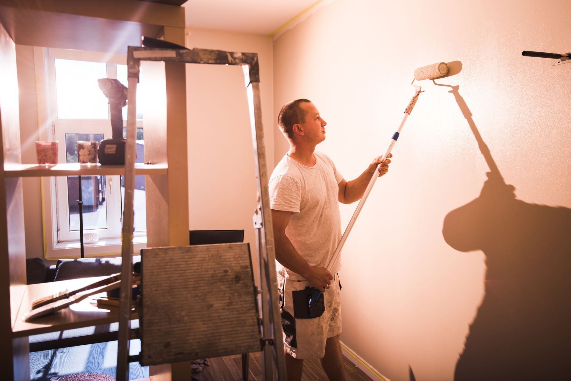 A Man Is Painting A Wall | Runcorn, QLD | GHM Painting Services