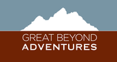 Logo for Great Beyond Adventures featuring a white mountain silhouette against a blue sky over a brown background.