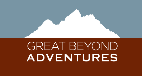 Logo for Great Beyond Adventures featuring a white mountain silhouette against a blue sky over a brown background.
