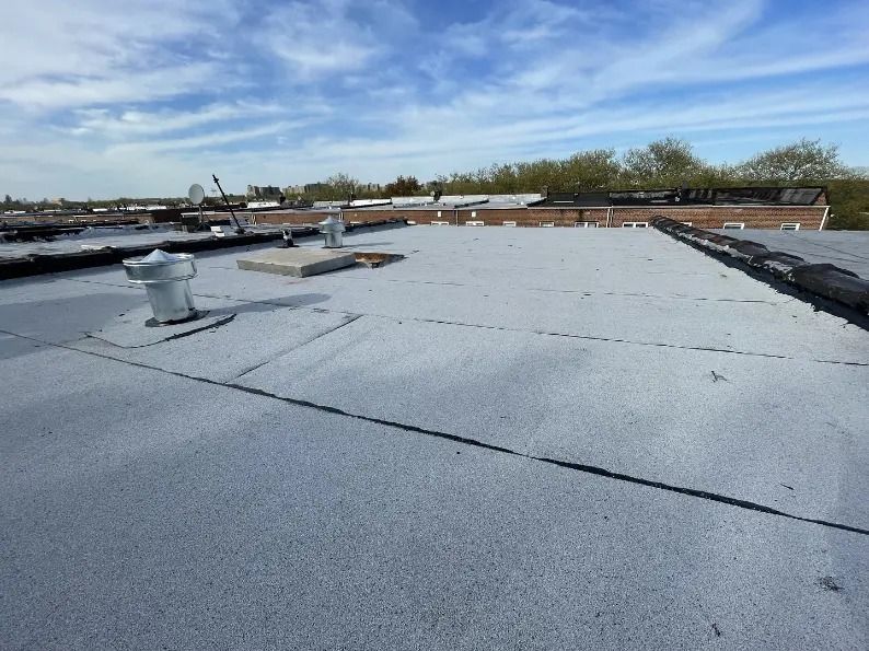 The roof of a building with a blue sky in the background
