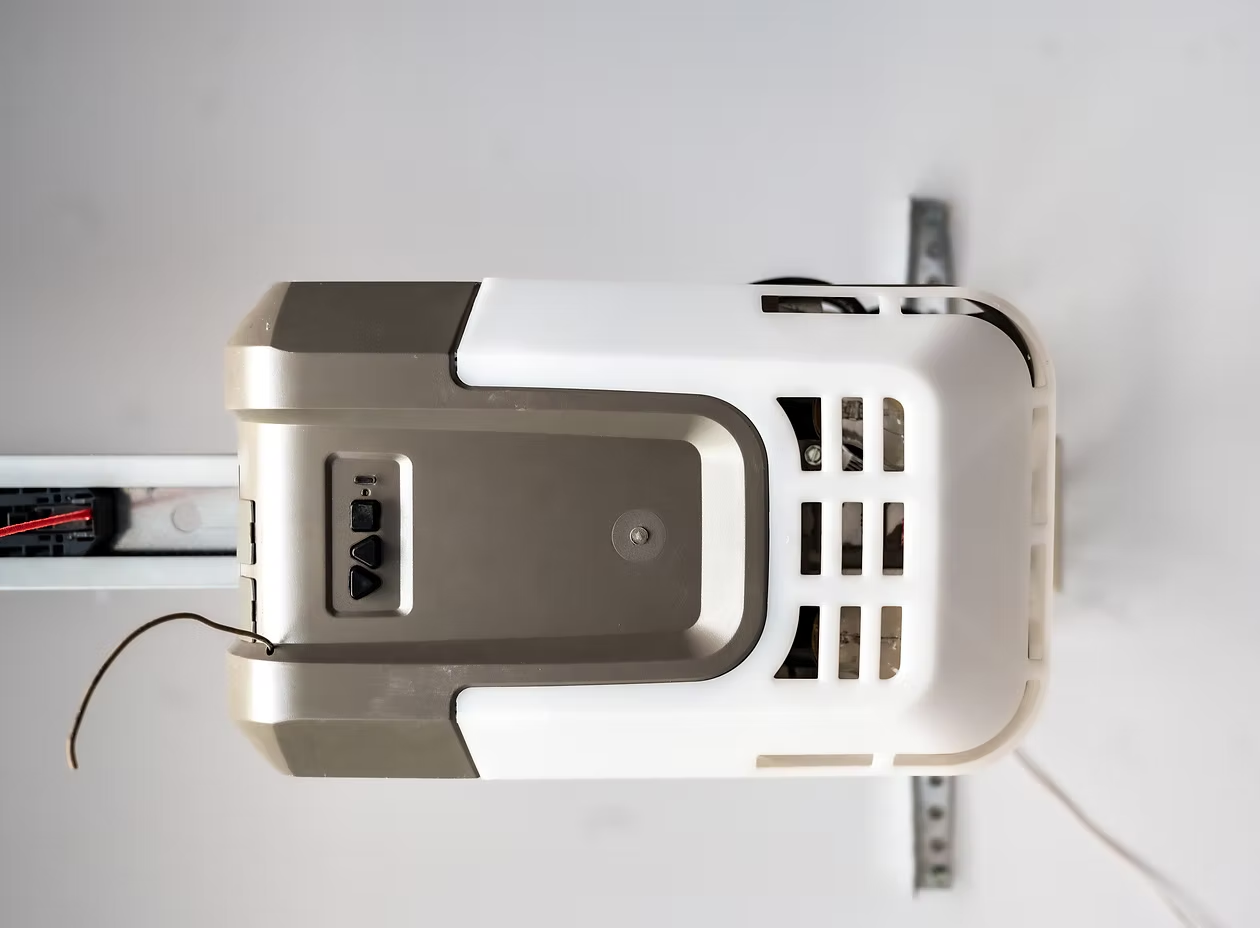 A white garage door opener is hanging from the ceiling