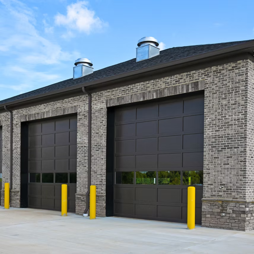 A brick building with a row of garage doors