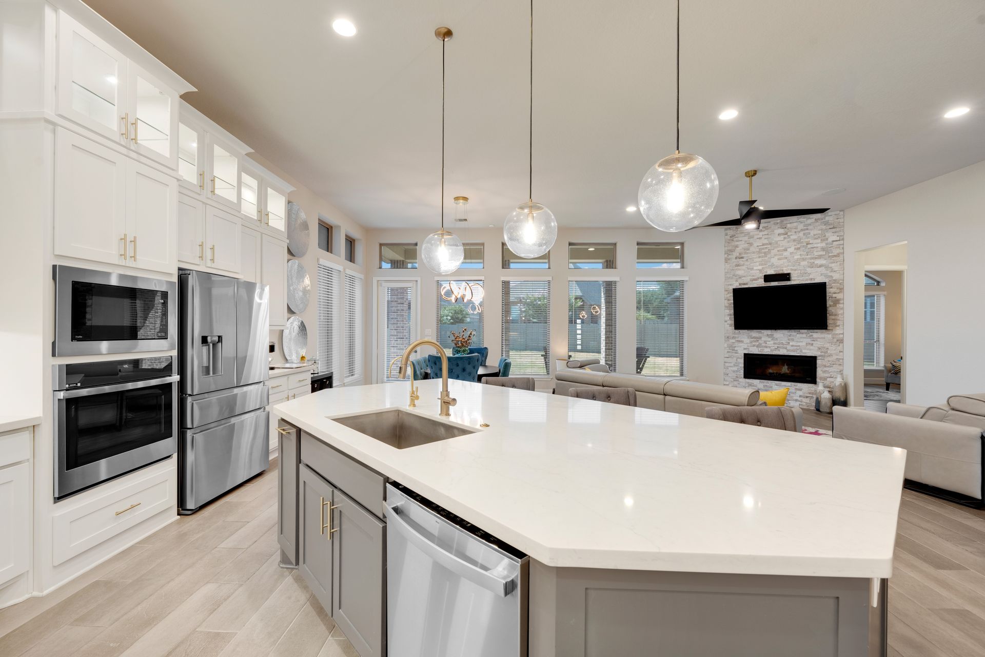 A kitchen with a large island and stainless steel appliances.