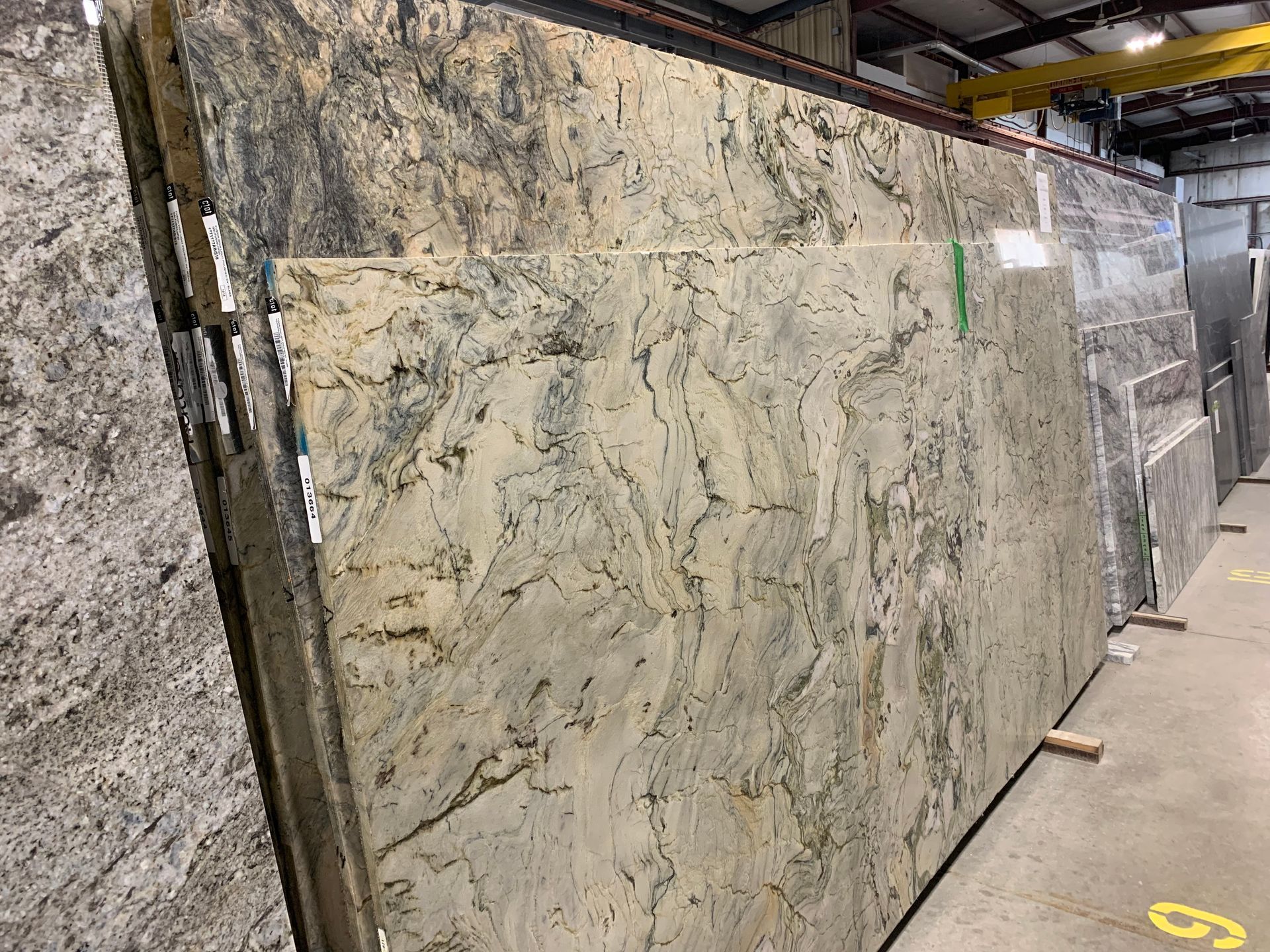 A large slab of granite is sitting in a warehouse.