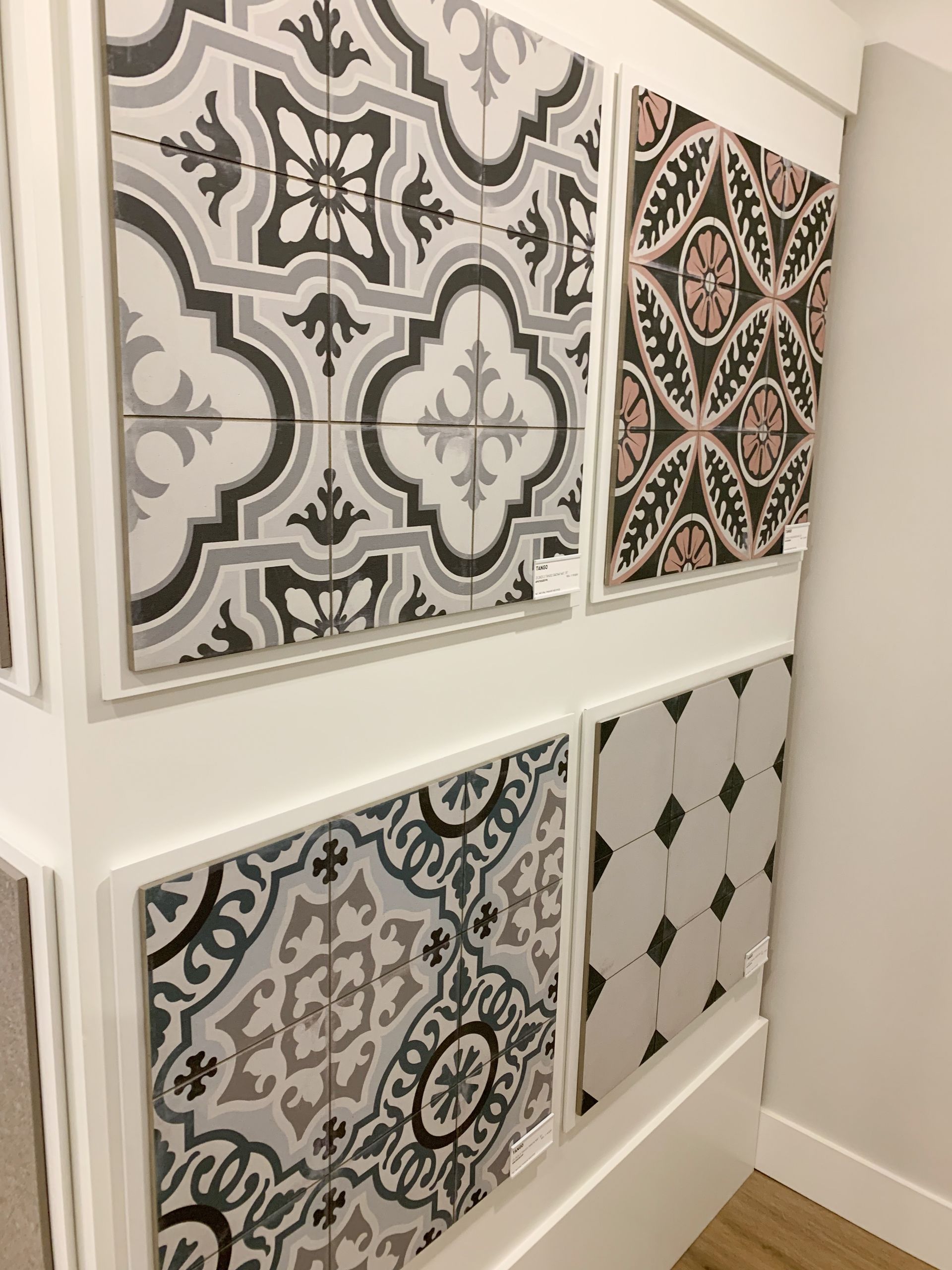 A wall with a variety of tiles on it