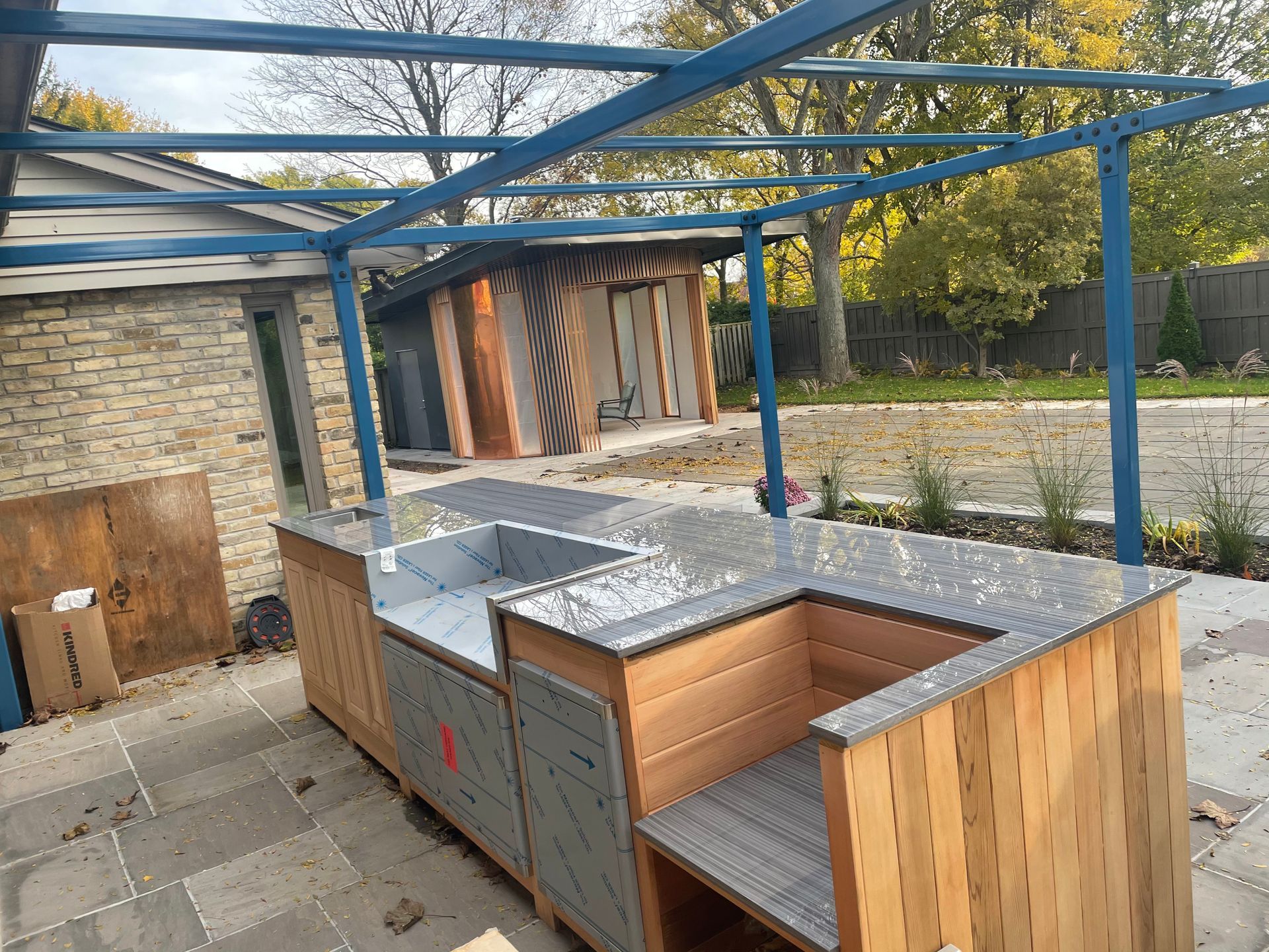 A kitchen is being built in the backyard of a house.