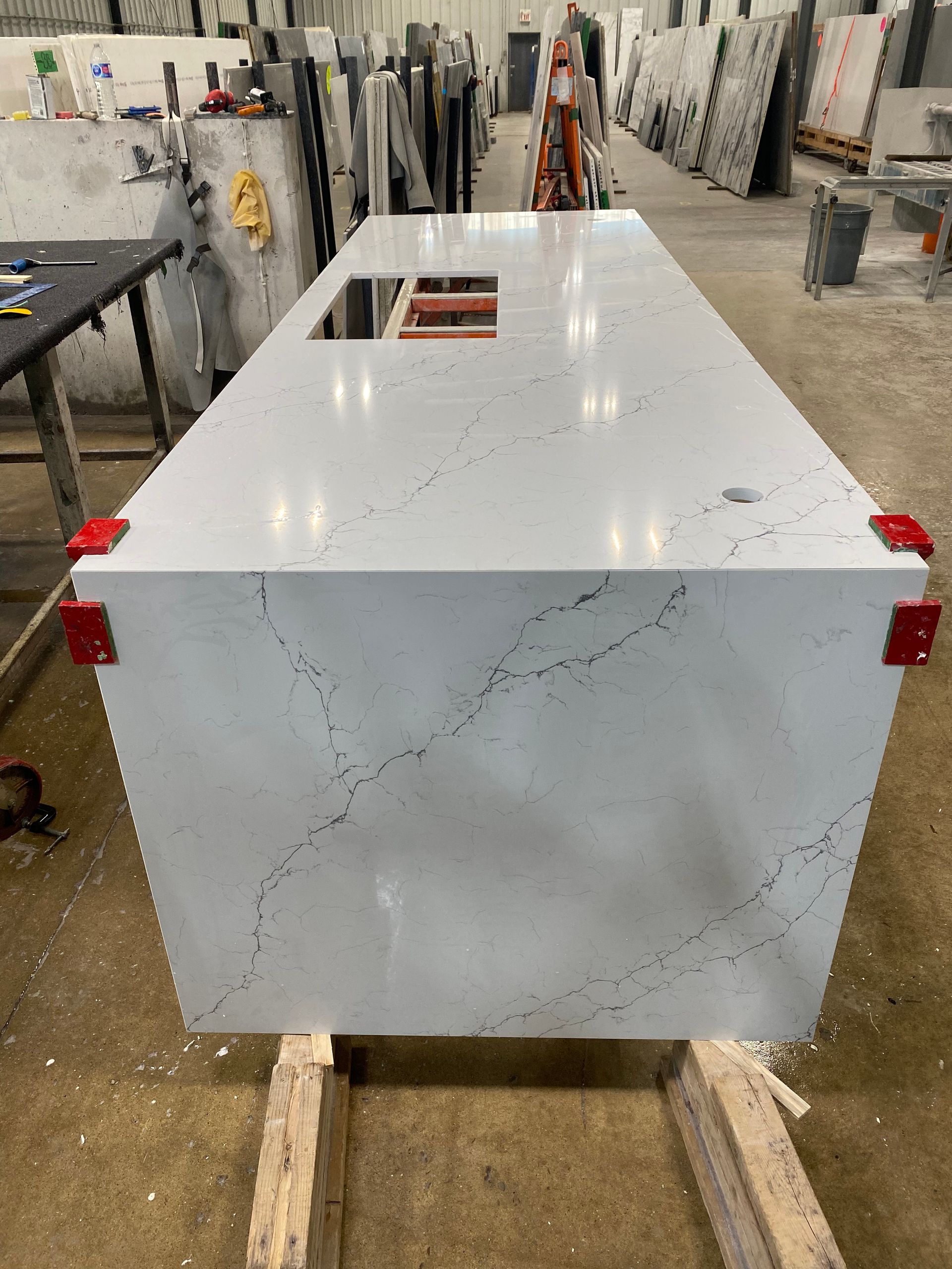 A large white counter top is sitting on top of a wooden table.