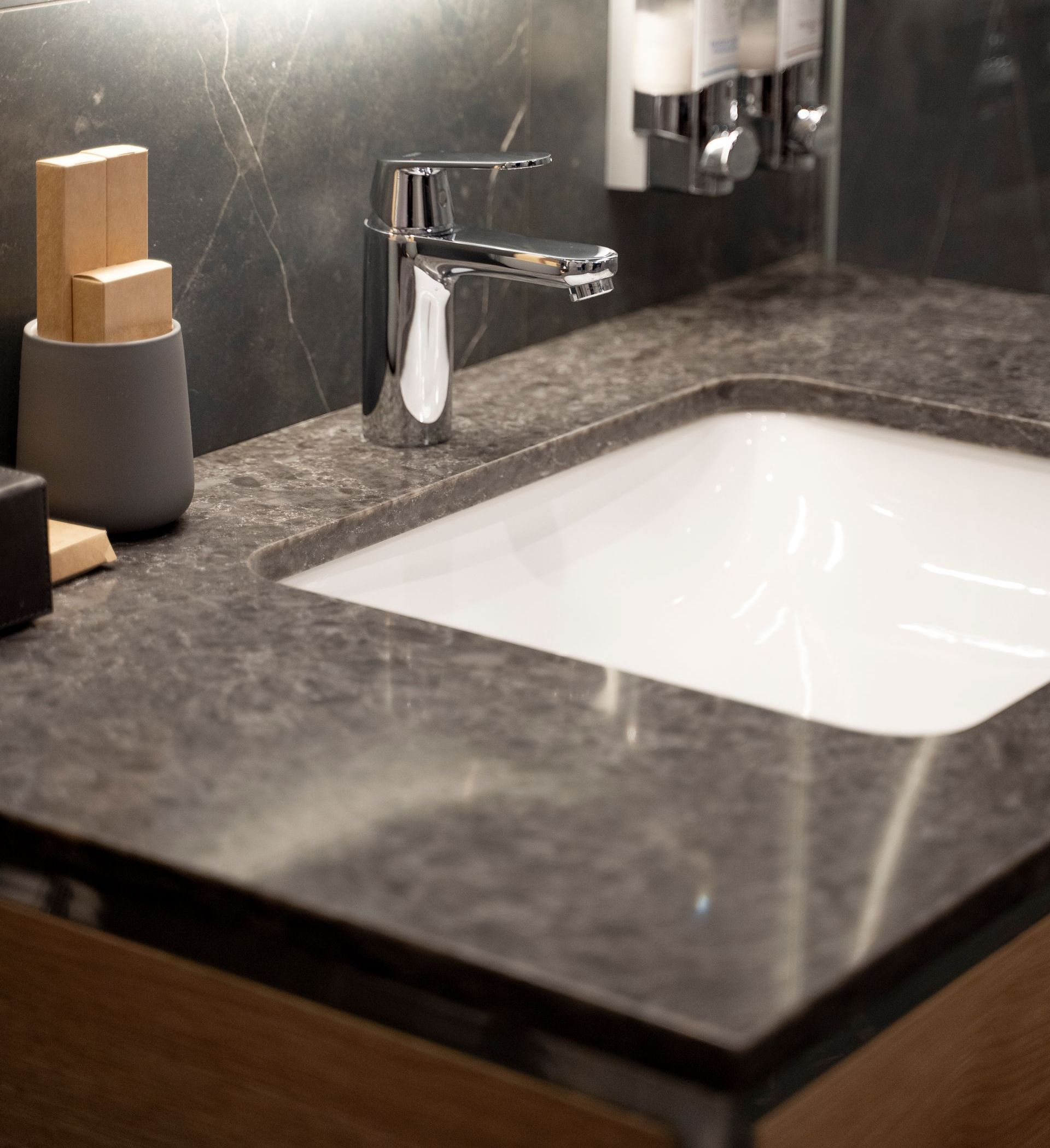 A bathroom counter with a sink and a faucet