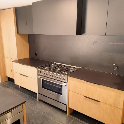 A kitchen with stainless steel appliances and wooden cabinets